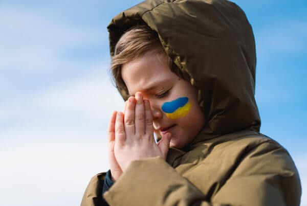 Ukrainian child with folded hands